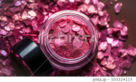Makeup cosmetics, glittery loose face shadows or blush, glitters in jar, pink glitter background, barbicor style. Beauty concept 103324115
