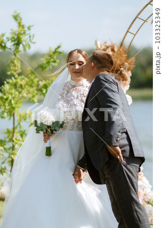 wedding ceremony of the newlyweds on the pier 103325349