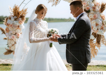 wedding ceremony of the newlyweds on the pier 103325361