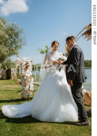 wedding ceremony of the newlyweds on the pier 103325369