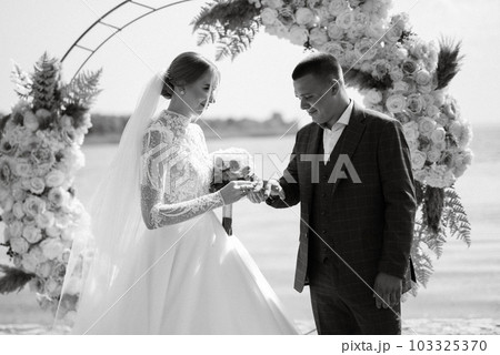 wedding ceremony of the newlyweds on the pier 103325370