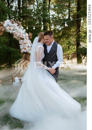 the first wedding dance of the bride and groom on a green meadow the first wedding dance of the bride and groom on a green meadow 103325404