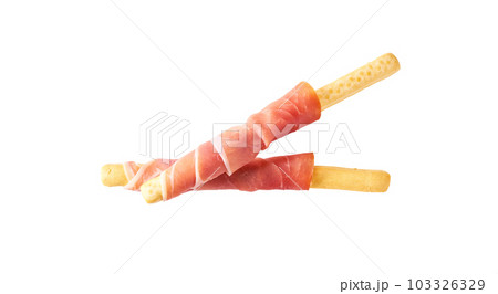 Parma ham prosciutto with Italian grissini breadsticks isolated on white background. 103326329