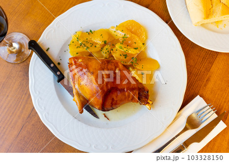 Roasted pork meat, toston asado with slices of potato Roasted pork meat, toston asado with slices of potato 103328150