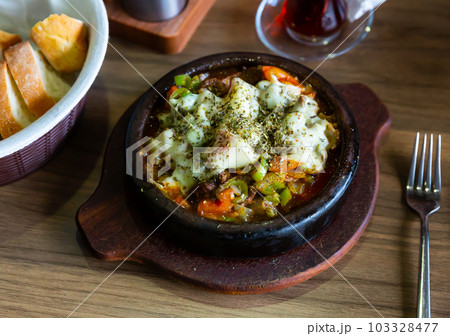 Beef stewed with sweet peppers, tomatoes and onions 103328477