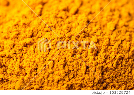Turmeric powder texture background, Ingredient in Asian cuisine, food coloring or natural dyeing Turmeric powder texture background, Ingredient in Asian cuisine, food coloring or natural dyeing 103329724