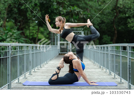 Beautiful female sport wear exercise arm stretching yoga in garden. sport for health. Beautiful female sport wear exercise arm stretching yoga in garden. sport for health. 103330743
