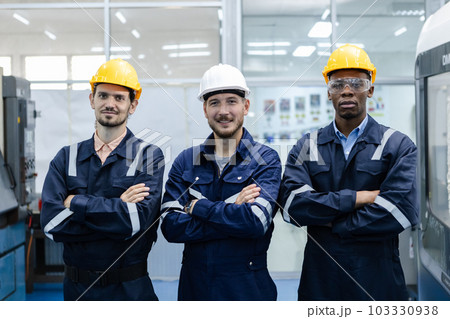 Teamwork engineers smiling wear helmets safety arm crosses partner success at factory workshop. Teamwork engineers smiling wear helmets safety arm crosses partner success at factory workshop. 103330938
