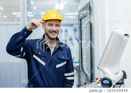 Portrait of happy smiling male engineer workers standing in manufacturing factory workplace. 103330939