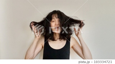 梅雨時湿気で髪がまとまらない日本人女性 梅雨時湿気で髪がまとまらない日本人女性 103334721