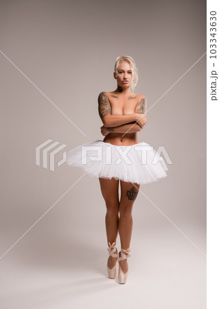 Naked woman in white ballet tutu in studio 103343630