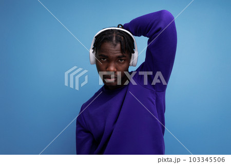 model appearance african young brunette man with dreadlocks with wireless headphones 103345506