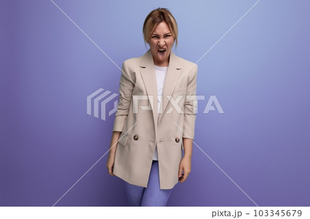 positive 30 year old woman in a jacket with blond hair on a studio background with copy space positive 30 year old woman in a jacket with blond hair on a studio background with copy space 103345679
