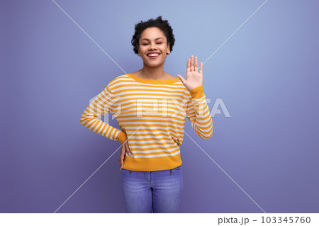 attractive latin young woman with afro hair in a yellow striped blouse 103345760