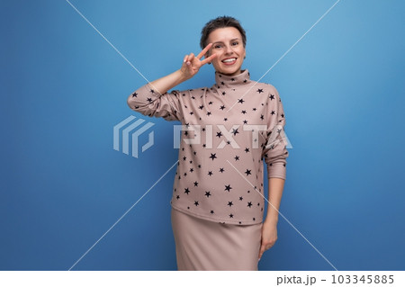 smiling well-groomed young career woman with gray streaked hair dressed in a skirt and blouse 103345885