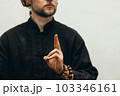 Hand with rosary shows the mudra of life. Qigong. Yoga. Close up. Hands folded in prayer. Hands together. Prayer, gratitude 103346161