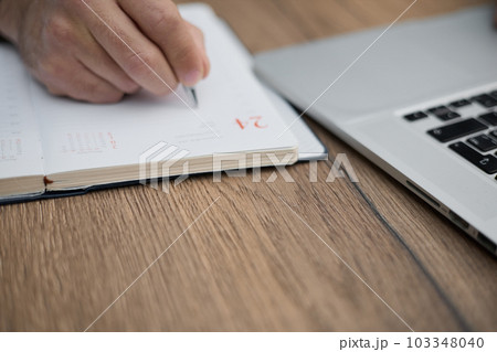 Businessman signing a document after reading the agreement in office 103348040
