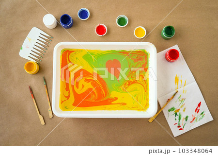 abstract drawing Ebru and set of tools on table. Traditional Turkish Ebru technique. top view. Children development concept 103348064