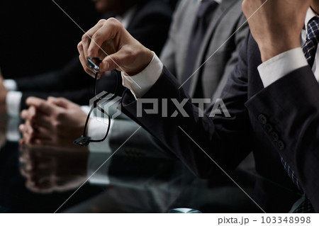 Close up of male hands holding a pair of glasses Close up of male hands holding a pair of glasses 103348998