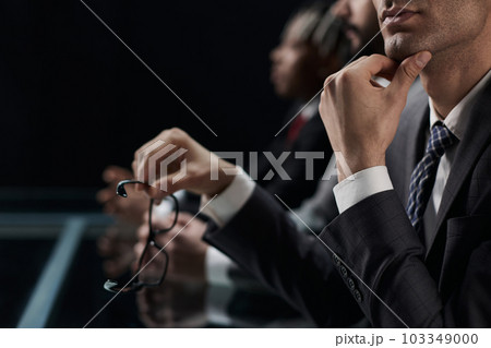 Close up of male hands holding a pair of glasses 103349000