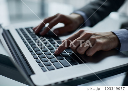 Close-up of male hands using laptop at office 103349077