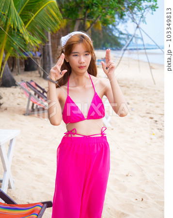 young girl sitting on the beach. by sea. tropical beach. summer style. 103349813
