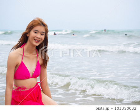young girl sitting on the beach. by sea. tropical beach. summer style. 103350032