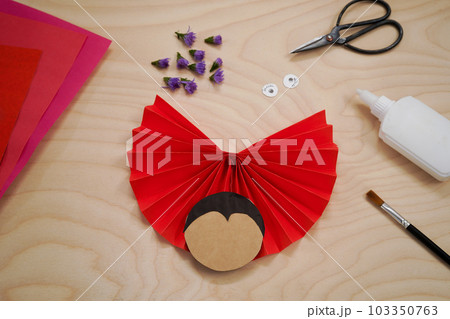 Step by step diy process handmade craft Ladybug made of paper and flowers. Step 6- glue the black haird. Red love symbol. 103350763