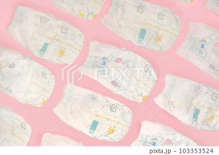 Baby diapers collection on pink color background. Newborn flat lay, top view. Pastel color. Baby care concept. Accessories for children's hygiene 103353524