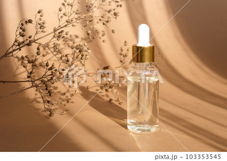 Natural oil cosmetics on neutral background. Dropper glass Bottle Mock-Up. Oily cosmetic pipette. Face and body treatment. Spa concept. Mineral organic oil. Flat lay with beauty products. Blank bottle Natural oil cosmetics on neutral background. Dropper glass Bottle Mock-Up. Oily cosmetic pipette. Face and body treatment. Spa concept. Mineral organic oil. Flat lay with beauty products. Blank bottle 103353545