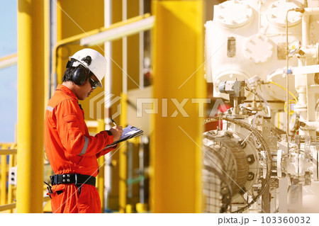 operator recording operation of oil and gas process at oil and rig plant, offshore oil and gas industry, offshore oil and rig in the sea, operator monitor production process, routine daily record. 103360032