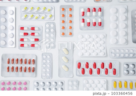 Various tablets and capsules in blisters on white background. Concept of healthcare and medicine. Top view Various tablets and capsules in blisters on white background. Concept of healthcare and medicine. Top view 103360456