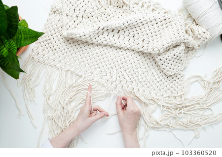 Creative hobby handmade macrame for home decoration. Girl weaves macrame. Woman weaving macrame panels for home decor. Flat lay, top view 103360520