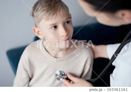 Doctor and kid boy patient at home medical inspection. Medicine, healthcare concepts Doctor and kid boy patient at home medical inspection. Medicine, healthcare concepts 103361161