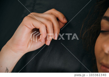 Capturing the Serenity: A Close-up of a Sleeping Woman's Beautiful Hand 103361340