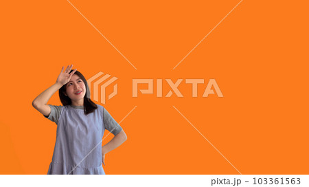 Young Asian woman thinking hard or planning to do something, Overthinking or worrying, Have a headache, Migraine, Stress, Free space for advertising or promoting products, Copy space, Enter text. 103361563