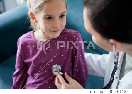 Happy smiling child patient at usual medical inspection. Doctor and kid patient at home. Medicine, healthcare concepts 103361582