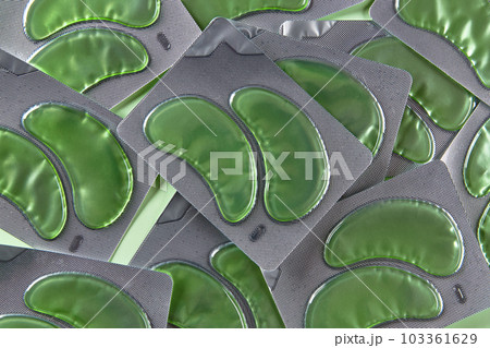 Eye patches set over green backgound. Face care beauty treatment concept Eye patches set over green backgound. Face care beauty treatment concept 103361629