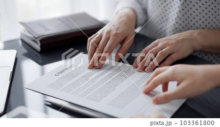 Business people discussing contract signing deal while sitting at the glass table in office, closeup. Partners or lawyers working together at meeting. Teamwork, partnership, success concept 103361800