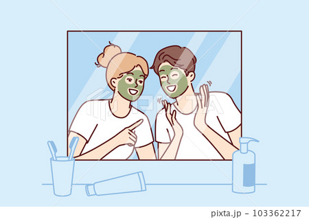 Cheerful couple with rejuvenating mask on faces look in mirror and laugh enjoying joint vacation 103362217