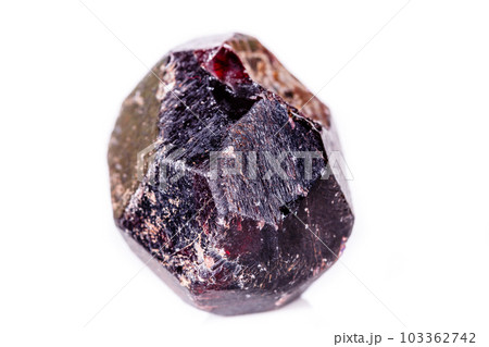 Macro of a mineral garnet stone on a white background 103362742