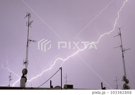Lightning. Storm. Ray. Right moment where the sky lights up in a storm due to lightning. Lightning in the storm. Ray. Thunder. Flash of lightning. Storm concept. Lightning flash. Electric torment. Lightning. Storm. Ray. Right moment where the sky lights up in a storm due to lightning. Lightning in the storm. Ray. Thunder. Flash of lightning. Storm concept. Lightning flash. Electric torment. 103362808