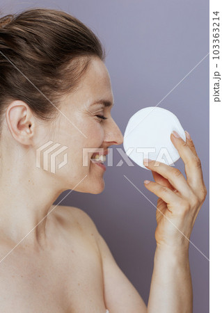 happy modern woman with cotton pad on blue happy modern woman with cotton pad on blue 103363214