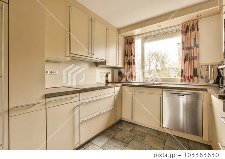 a kitchen with white cabinets and silver appliances on the counter tops in front of the dishwasher, which has been used for 103363630