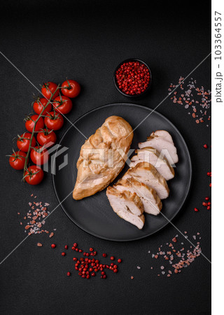 Delicious fresh grilled chicken fillet with salt, spices and herbs on a ceramic plate 103364557