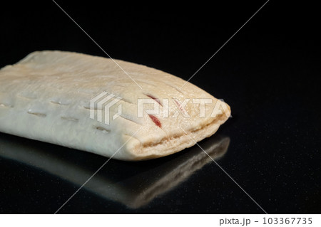 Uncooked bun with red strawberry jam on tray in electric oven: close up 103367735