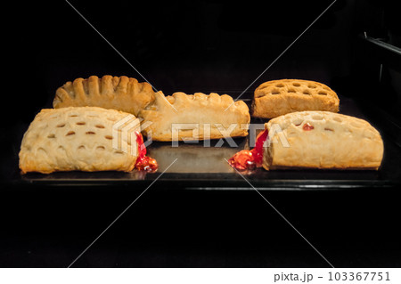 Five baked homemade buns with fruit jam in electric oven 103367751
