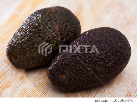 Ripe avocado on wooden table Ripe avocado on wooden table 103369470