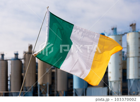 Flag of ireland flying with pride in front of industrial scenery Flag of ireland flying with pride in front of industrial scenery 103370002