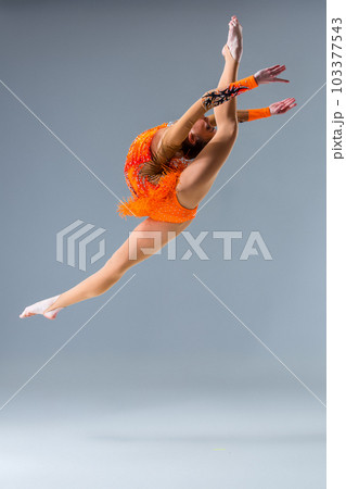 Young slim gymnast in studio Young slim gymnast in studio 103377543
